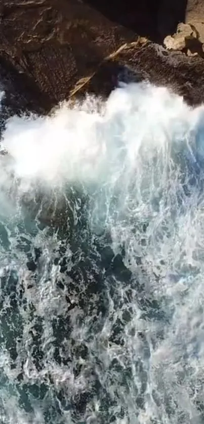 Stunning aerial view of ocean waves crashing against rocky cliffs.