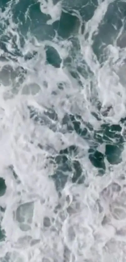 Overhead view of ocean waves crashing and foaming.