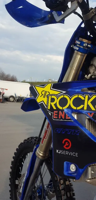 Blue off-road motorcycle with sponsor logos.