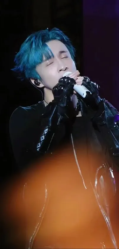 Singer performing passionately on stage with striking blue accents.