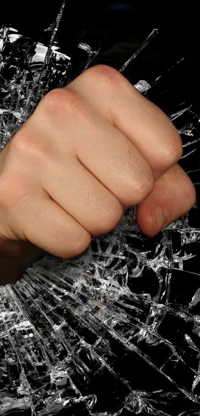 A fist breaking through shattered glass on a black background.