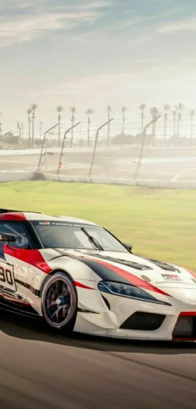 Dynamic racing car speeding on track with clear blue sky.