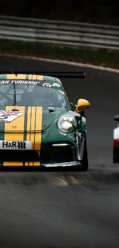 Green racing car leading on a curved race track with another car following.