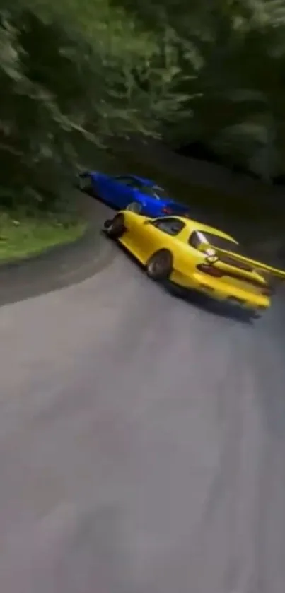 Yellow and blue cars drifting on a forested road.