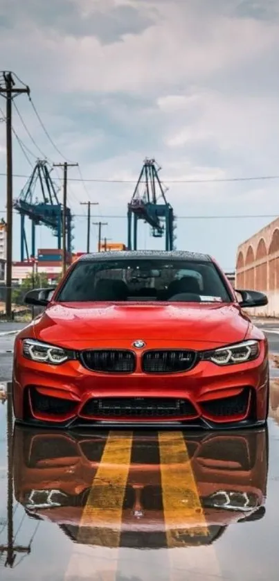 Dynamic red car on a wet urban street with reflection.