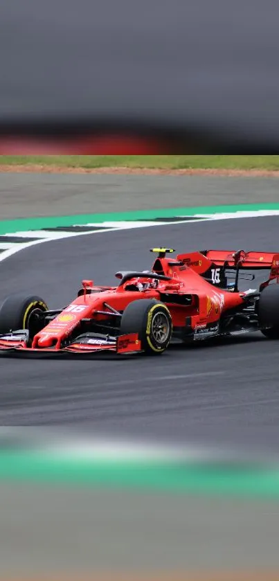 Red Formula 1 car racing on a track.