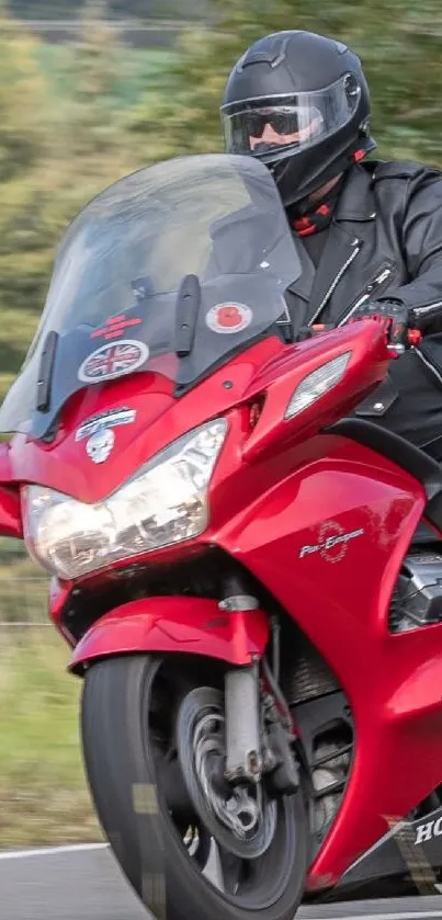 Red motorbike with rider in helmet on a scenic road.