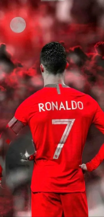 Soccer player in red jersey with a dramatic sky background.