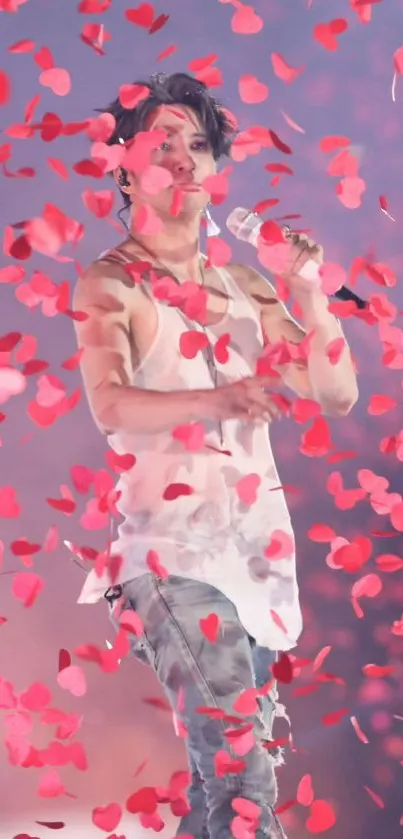 Singer energetically performing amidst cascading pink petals on stage.