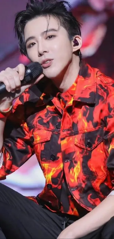 Singer on stage in a fiery red jacket during a live concert performance.