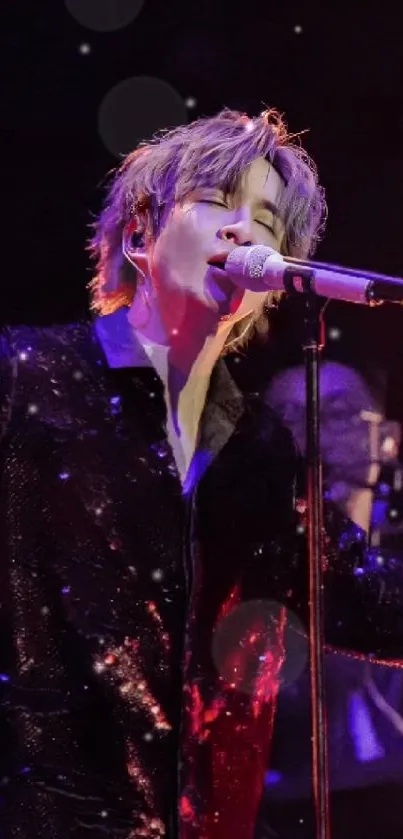 Singer performing passionately on stage in deep violet lighting.