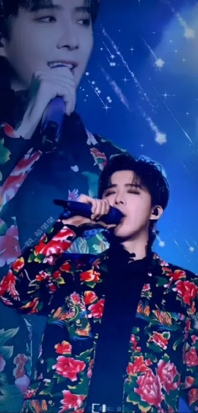 Singer in floral jacket performing with blue starry backdrop.