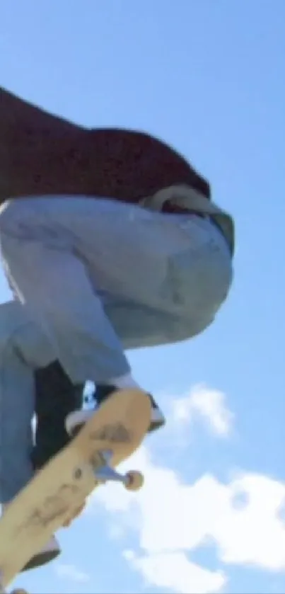 Skater performing an aerial trick against a blue sky.