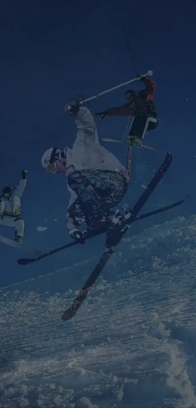 Skiers and snowboarder in mid-air on snowy mountain slopes.