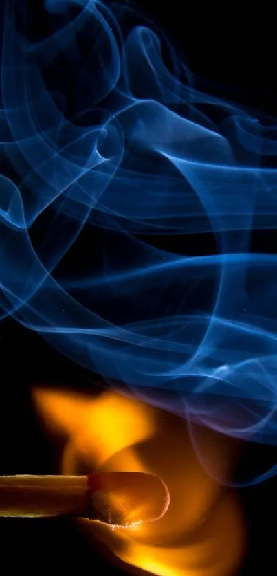 Blue smoke and orange flame on matchstick against black backdrop.