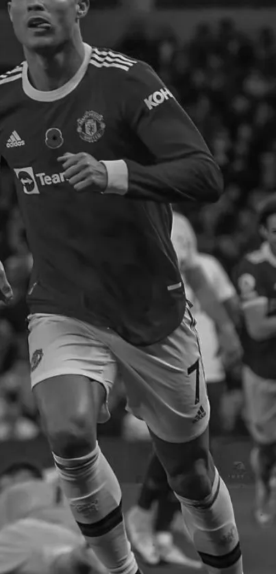 Black and white image of a soccer player in action on the field.