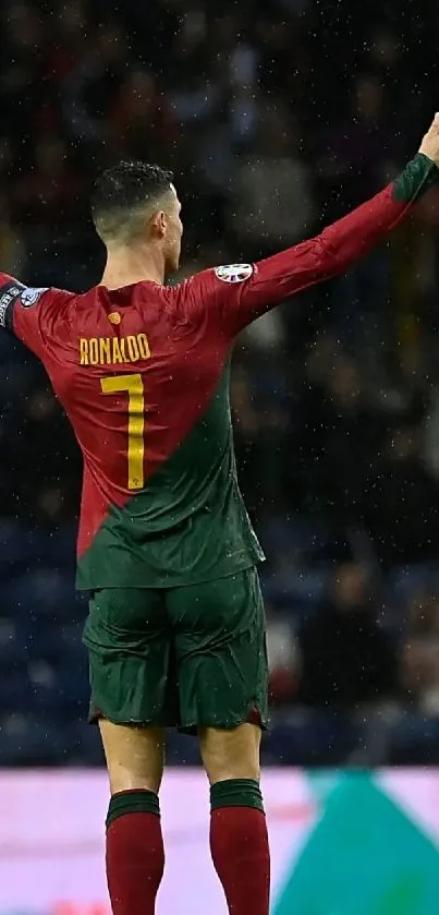 Dynamic soccer scene with player celebrating on the field wearing red and green.