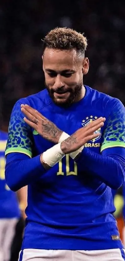 Soccer player celebrating in blue jersey on field.