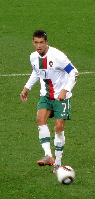 Focused soccer player on green field during match.