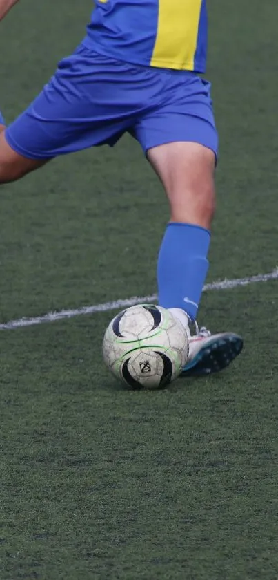 Soccer player kicking ball on green field.