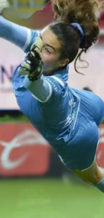 Female soccer goalie in dynamic leap and dive pose.