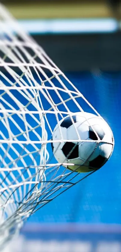 Soccer ball hitting net against blue background.