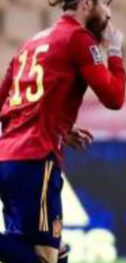 Soccer player in red jersey running on the field.