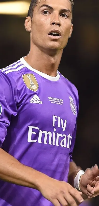 Soccer player in purple jersey striking a pose on the field.