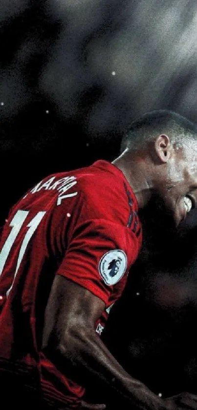 Football player celebrating in red jersey under spotlight.