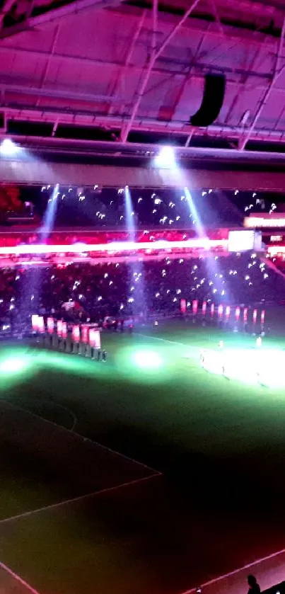 Stadium filled with vibrant neon lights during a night football game.