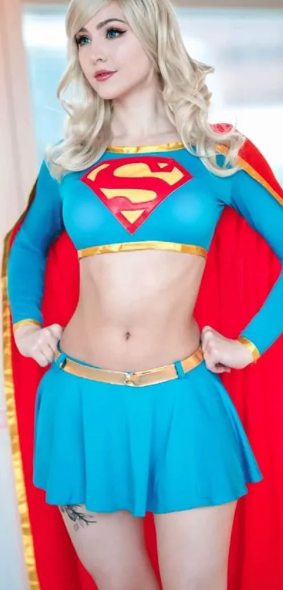 Cosplay superheroine in dynamic pose with colorful costume and red cape.