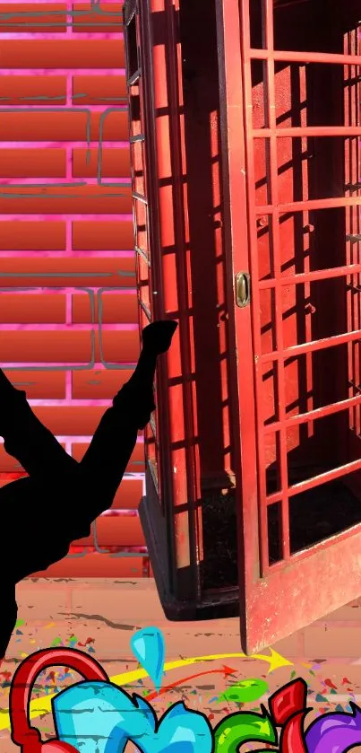 Silhouette breakdancer by red phone booth with graffiti.