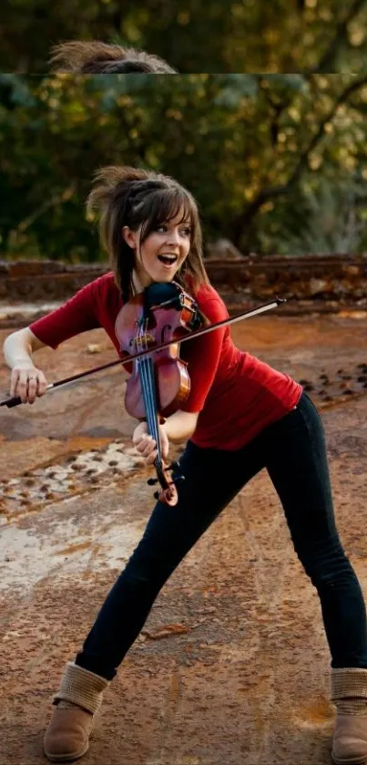 Young violinist playing energetically outdoors on a rustic backdrop.