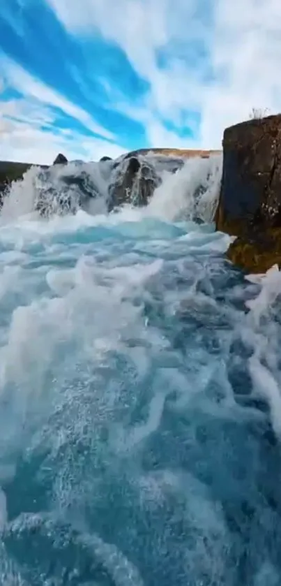 Dynamic blue waterfall over rocks in nature.