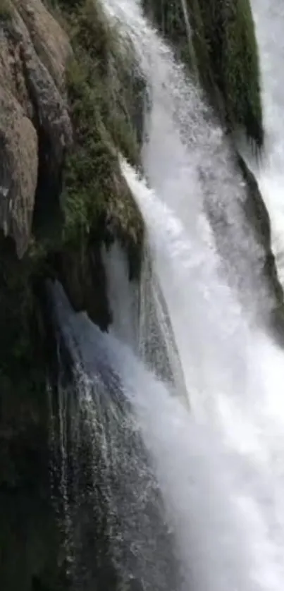 Dynamic waterfall cascading down rocks, creating a tranquil scene.