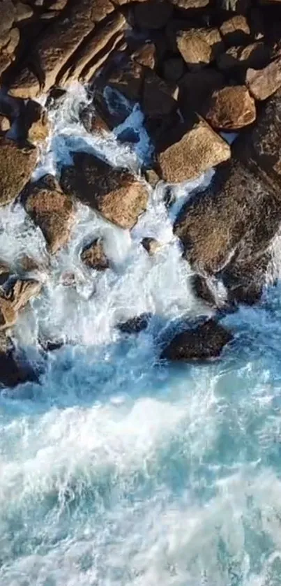 Ocean waves crashing on rugged rocks in vibrant blue hues.