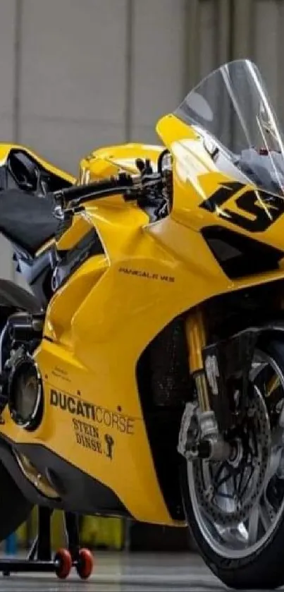 Sleek yellow sports motorcycle parked indoors.