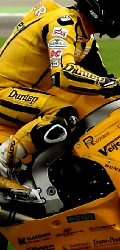 Yellow motorcycle and rider in action on track.