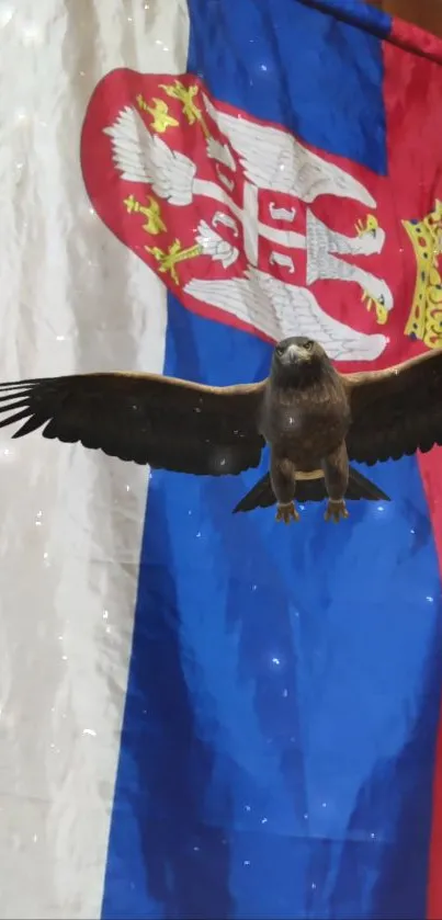 Eagle flying in front of a colorful national flag.