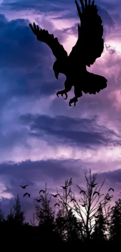 Silhouette of an eagle soaring against a twilight sky with clouds.