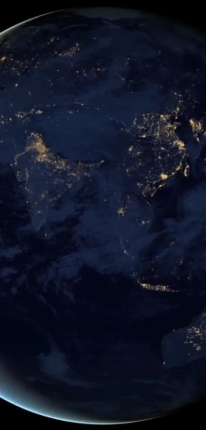 Earth at night with glowing city lights against a dark blue background.