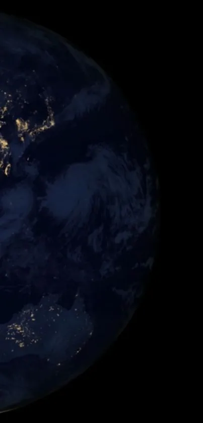 Earth at night with illuminated continents on a dark space background.