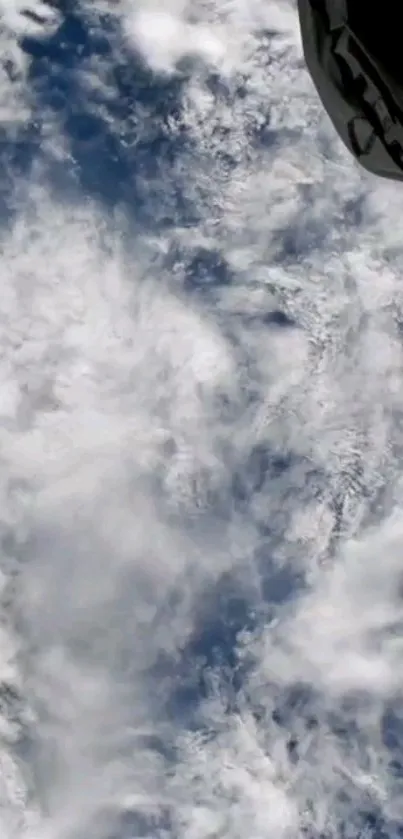 Cloudy view of Earth from space in vibrant blue tones.