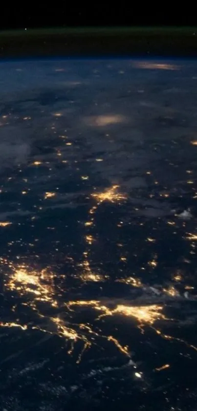 Night view of Earth's illuminated cities from space, showcasing bright lights.