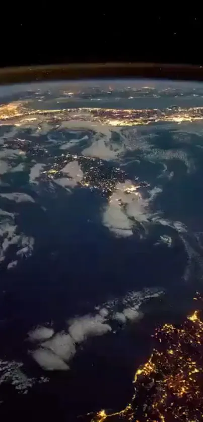 Earth from space at night with glowing city lights and blue ocean.