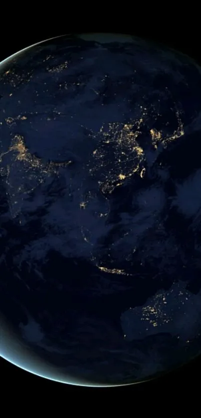 Earth illuminated from space at night with visible city lights.