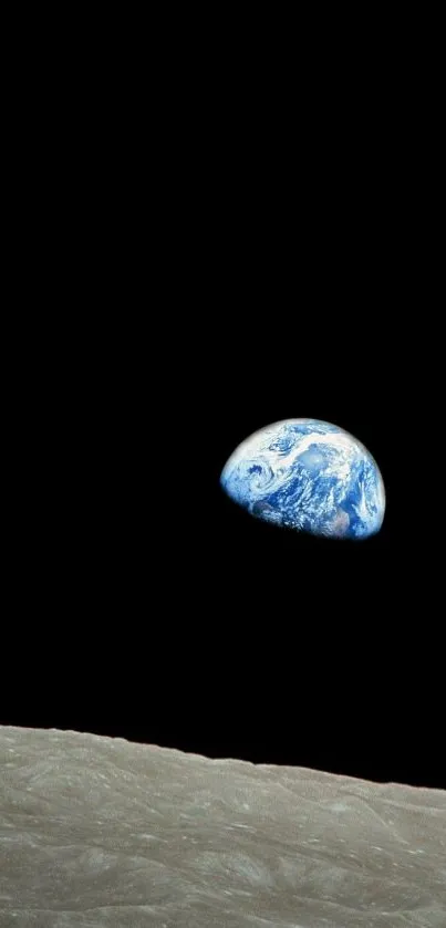 Stunning view of Earth rising above the moon's horizon in space wallpaper.