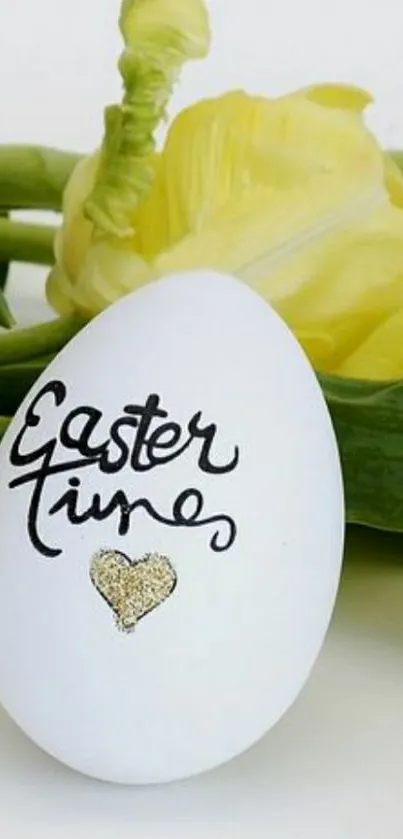 White egg with Easter message and yellow tulips.