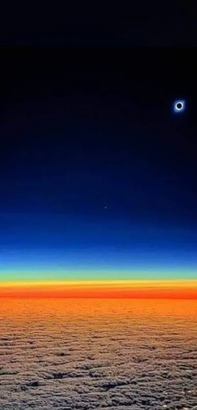 Solar eclipse over colorful horizon with clouds and vibrant sky hues.