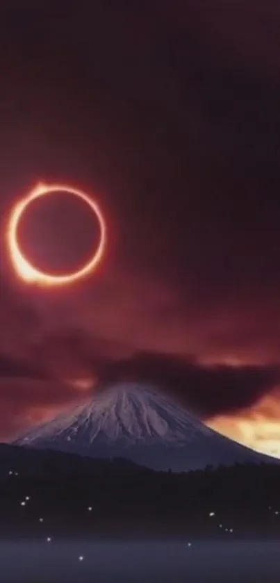 Eclipse over a snow-capped mountain with a darkened sky.